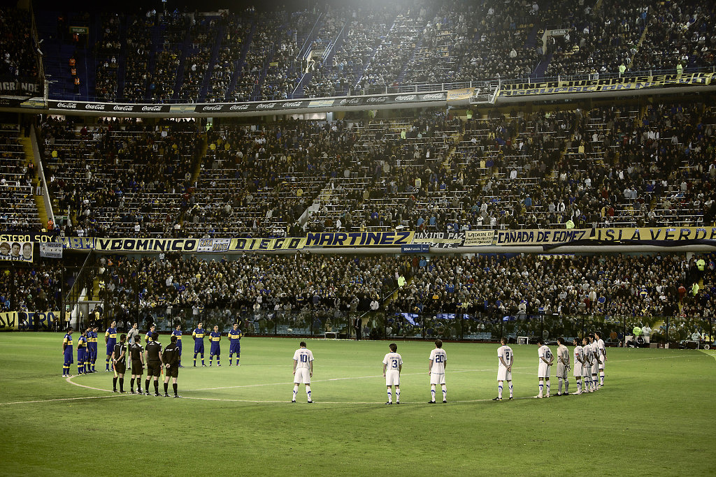 Diego Maradona covered in mud during a match Boca Juniors against